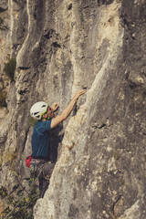 Obraz premium A Man Climbing a Rock