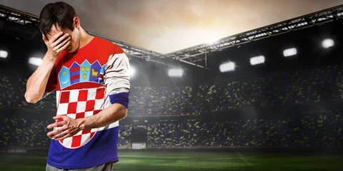 Poster Croatia national team. Sad soccer or football player on stadium © Sergey Peterman