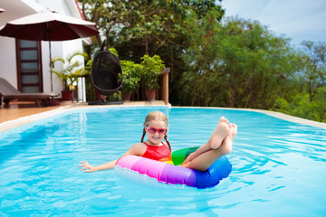 Child in swimming pool. Kids swim. Water play.