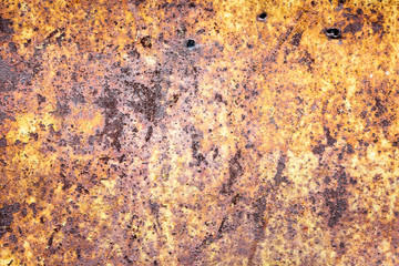 Vintage background of rusty metal sheet with exfoliated yellow paint