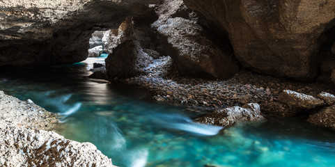 Panorama of the underground lake in a cave of bright blue color - Powered by Adobe