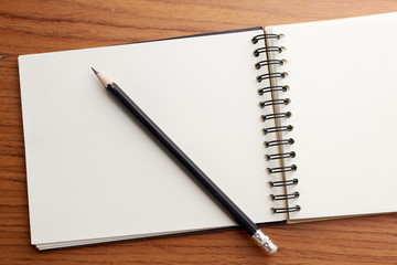 Writing on Notebook With Pencil
