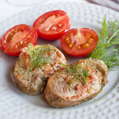 Delicious pieces of baked meat with fresh vegetables on the table