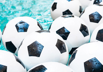 Many black and white soccer balls background. Football balls in a water. World cup 2018
