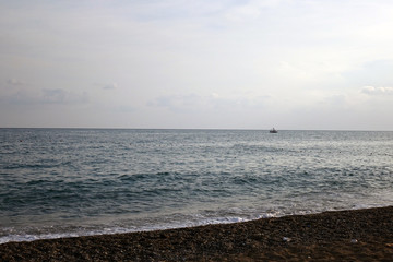 Pebble beach and blue sky on background