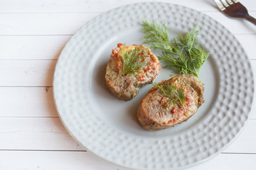 Delicious pieces of baked meat with fresh vegetables on the table