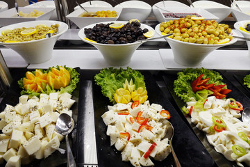 Mixed cheeses in the cupboard .Cheese platter with vegetables .