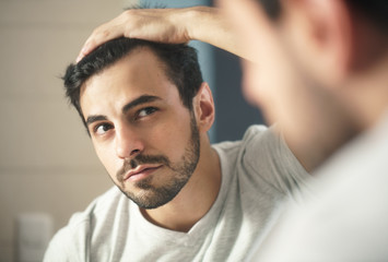 Man Worried For Alopecia Checking Hair For Loss - obrazy, fototapety, plakaty
