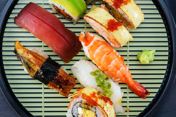 japanese sushi set on disk and black stone