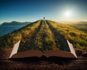 Girl hiker with backpack on the pages of book