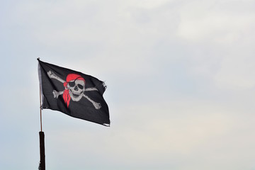 Pirate flag in the blue sky