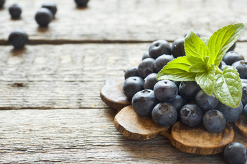 Blueberries on old wooden dishes, space for text