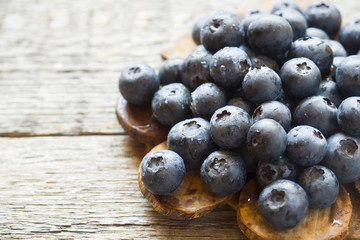 Blueberries on old wooden dishes, space for text