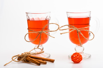 Hot drinks concept. Glasses with mulled wine or hot drink tied with twine string on white...