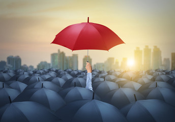 businessman with red umbrella among others, unique different concept - obrazy, fototapety, plakaty