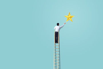 businessman climb up on ladder to reach star, successful and win concept