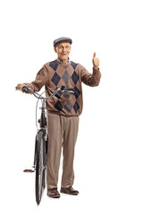 Senior with a bicycle making a thumb up sign