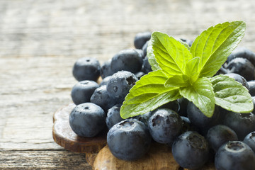 Blueberries on old wooden dishes, space for text