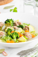 Vegetable soup with beef meatballs, carrots, cabbage, zucchini, broccoli, healthy homemade lunch