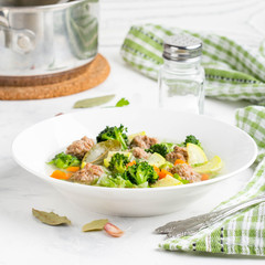 Vegetable soup with beef meatballs, carrots, cabbage, zucchini, broccoli, healthy homemade lunch