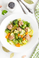 Vegetable soup with beef meatballs, carrots, cabbage, zucchini, broccoli, healthy homemade lunch