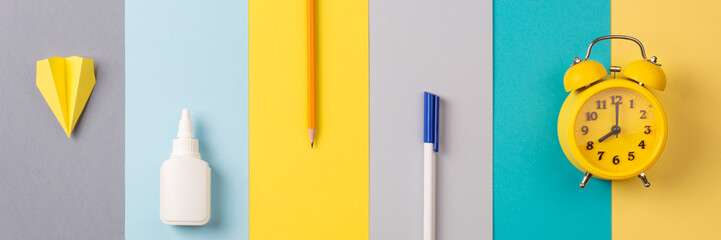 school and office supplies on bright striped background. minimum set in yellow, blue, gray color:...