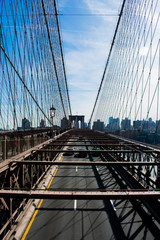 Fototapeta premium Brooklyn bridge over water, blue sky with sunshine