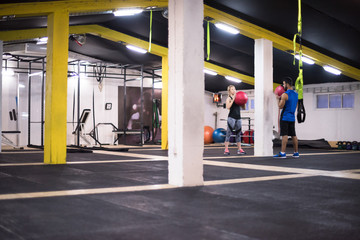 young athletes couple working out with medical ball