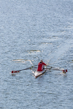 Two older men rowing a Sculling boat