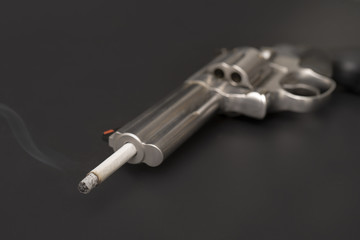 Naklejka premium Smoking cigarette like suicide with gun,dangeruous to lung,smoking quit concept.