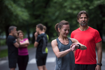 Fototapeta premium sporty couple using smart watches