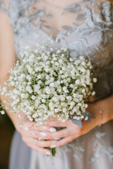 Obraz na płótnie Canvas Bridesmaide holding a bouquet. Cropped image