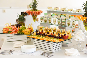 Delicious desserts on buffet table at the wedding