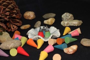 Colorful incense cone on black background