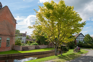 A picturesque scene in the English village of Eardisland, by the riverbank scenery in the summertime.