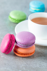 Photo of cake macarons, gift box, tea, coffee, cappuccino and flowers. Sweet romantic food macaroon concept. Morning breakfast and presents. Valentine's day concept.