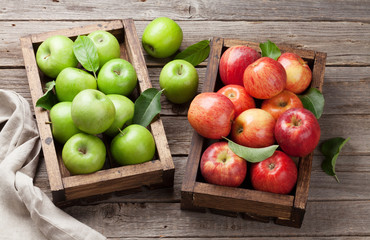 Green and red apples in wooden box