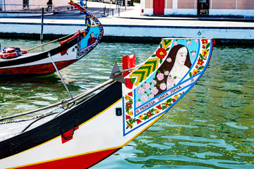 Fototapeta na wymiar Painted boats on the canal of Aveiro