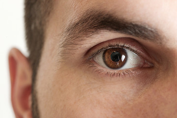 Close up view of a brown man eye looking at camera - Powered by Adobe