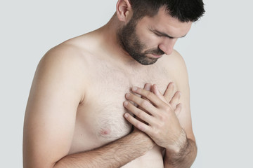 Chest Pain, Young man holding hand to spot chest pain