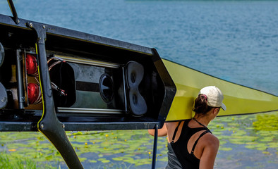 Women's rowing team carries a boat on its shoulders