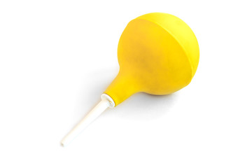 Yellow enema syringe isolated on white background. Poisoning concept. Bowel problems.