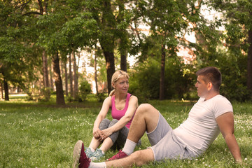 Couple relaxing after physical training session .