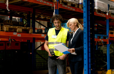 Manager and employee in warehouse