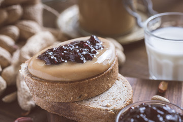 Fresh Peanut Butter and Jelly Sandwich on Old Rustic Wooden Cutting Board