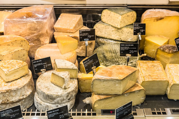 Different cheeses on display in a French supermarket. Paris, France - 209901381