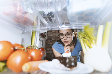 Woman taking healthy food from the fridge