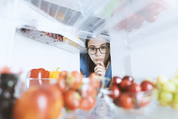 Woman taking healthy food from the fridge