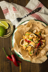 Fresh Greek Squids Calamari with Red Hot Chili Pepper on Rustic Wooden Background