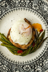 Freshly Poached Egg on Toast With Boiled Green Asparagus and Chili Peppers
